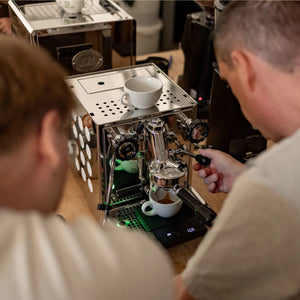 Teilnehmer des Barista Kurses in Kaarst ziehen Espresso an einer Siebträgermaschine.